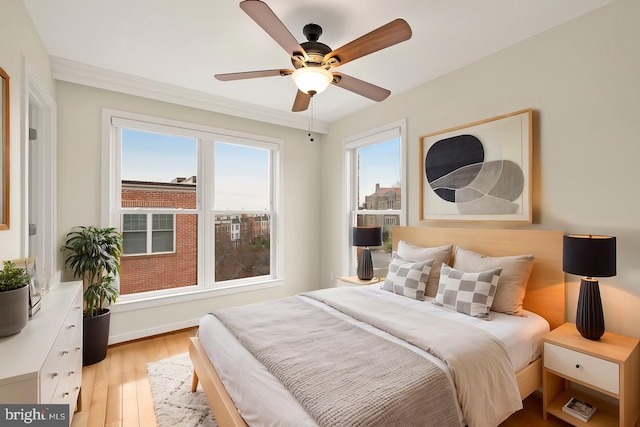 bedroom with ceiling fan and wood finished floors