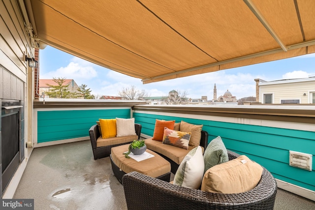 view of patio with a view of city, outdoor lounge area, and a balcony