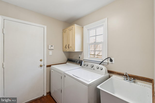 washroom featuring a sink, cabinet space, and washer and dryer