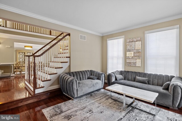 living room with stairs, dark wood finished floors, visible vents, and crown molding