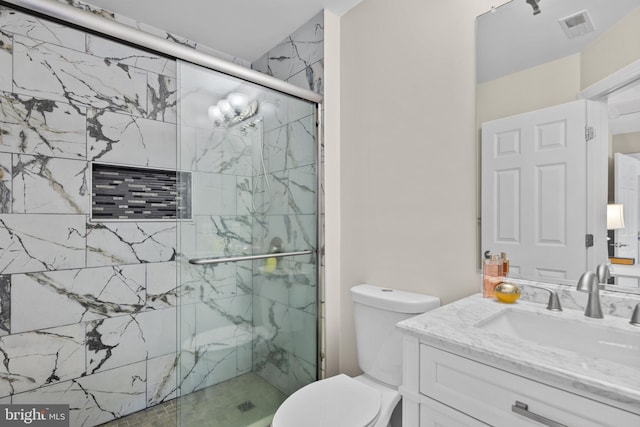 full bathroom with toilet, a stall shower, visible vents, and vanity