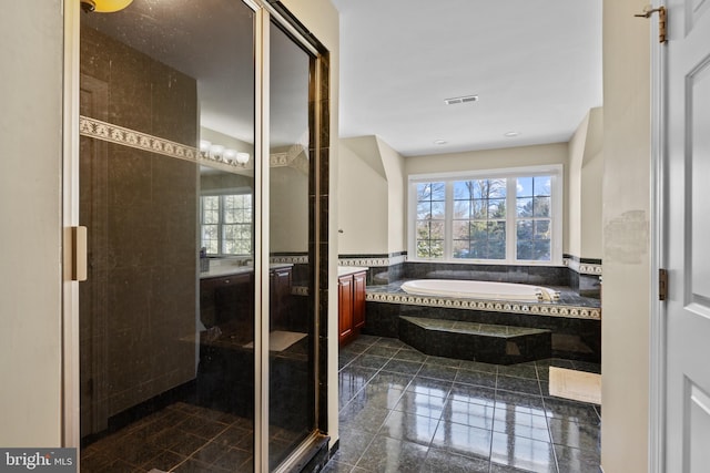 full bathroom with a wealth of natural light, a garden tub, vanity, and a shower stall