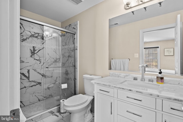 bathroom featuring a marble finish shower, visible vents, toilet, marble finish floor, and vanity
