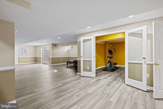 basement with recessed lighting, french doors, baseboards, and light wood finished floors
