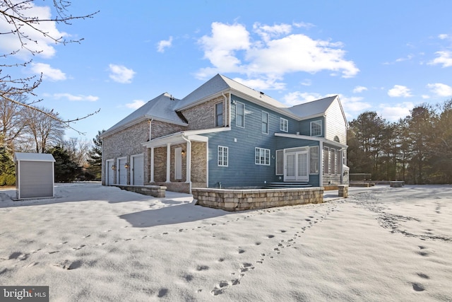 back of house with a garage and brick siding