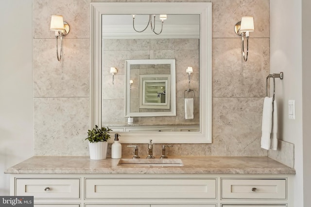 bathroom featuring ornamental molding, decorative backsplash, and vanity