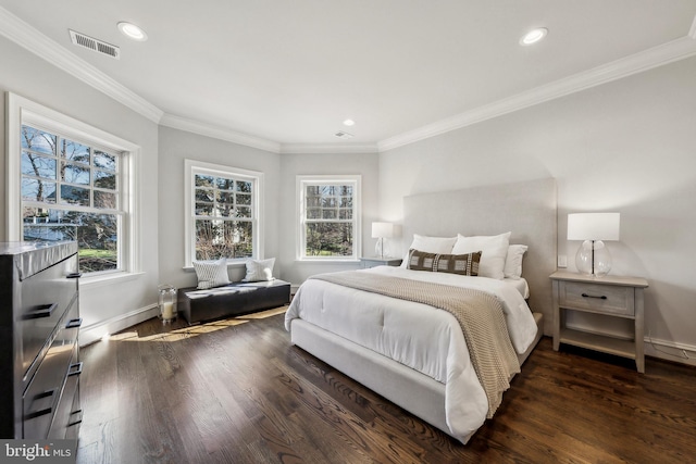 bedroom with multiple windows, wood finished floors, and visible vents