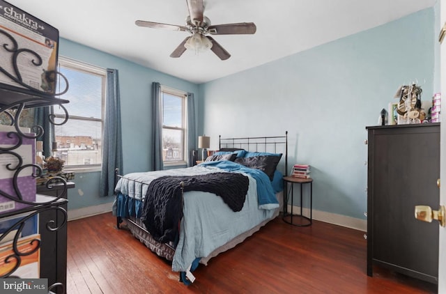 bedroom featuring dark wood-style floors, baseboards, and a ceiling fan