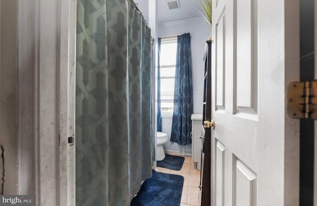 bathroom featuring toilet, tile patterned flooring, and visible vents