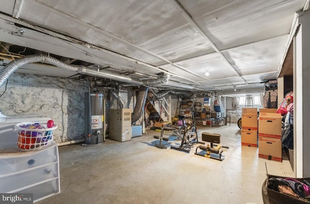 basement featuring heating unit and water heater