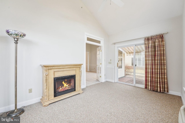 unfurnished living room featuring high vaulted ceiling, light colored carpet, a ceiling fan, baseboards, and a glass covered fireplace