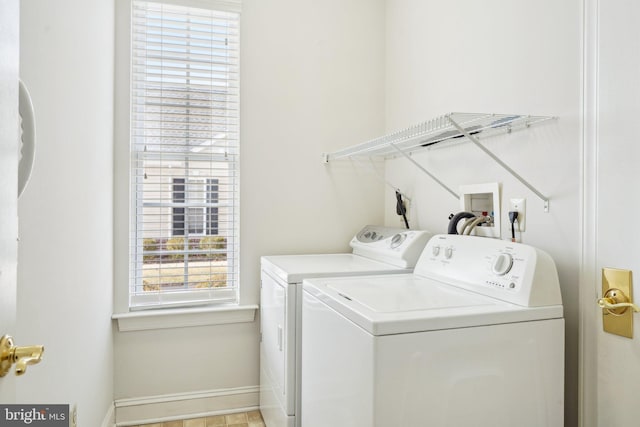 clothes washing area with laundry area, independent washer and dryer, and baseboards