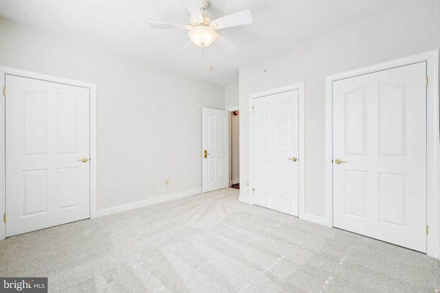 unfurnished bedroom with a ceiling fan, light carpet, and baseboards