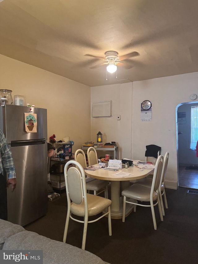 dining area featuring ceiling fan and dark wood-type flooring