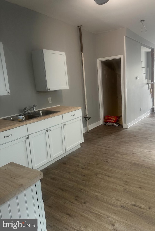 kitchen featuring sink, white cabinets, dark hardwood / wood-style floors, and wooden counters