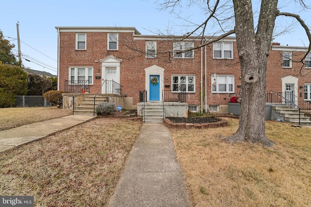 multi unit property featuring brick siding and fence