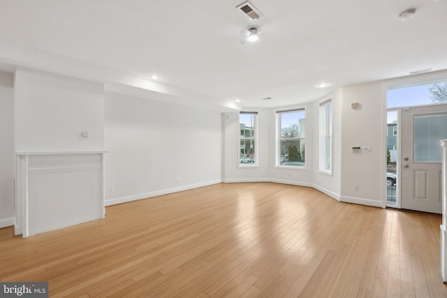 unfurnished living room featuring light wood-style flooring, recessed lighting, visible vents, and baseboards