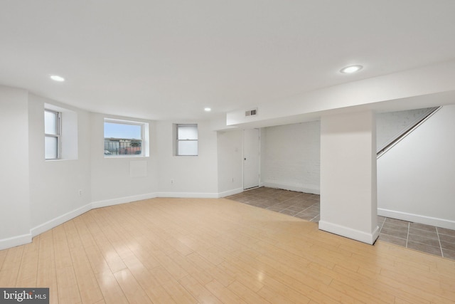 below grade area with recessed lighting, wood finished floors, and baseboards