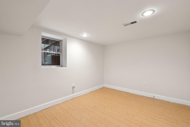 spare room featuring recessed lighting, wood finished floors, visible vents, and baseboards