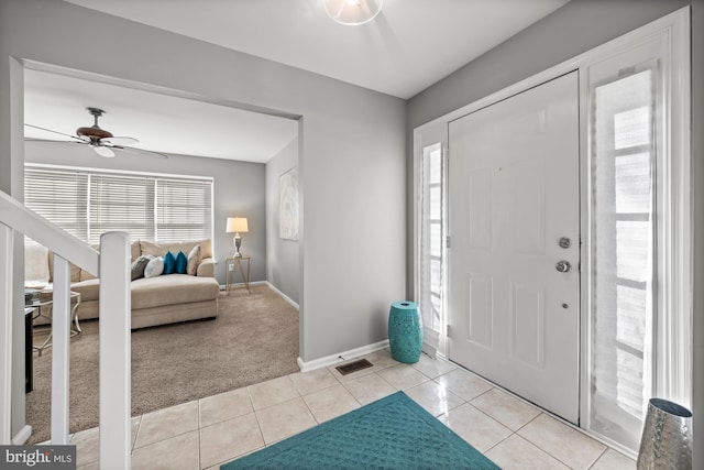 foyer entrance featuring ceiling fan and light tile patterned flooring