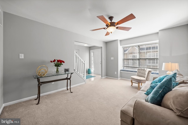 carpeted living room featuring ceiling fan