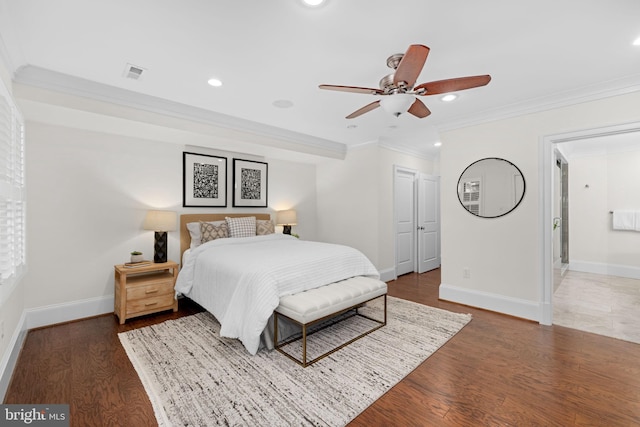 bedroom featuring ensuite bathroom, ceiling fan, dark hardwood / wood-style floors, and ornamental molding