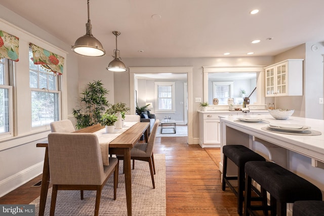 dining space featuring baseboards, recessed lighting, and light wood-style floors