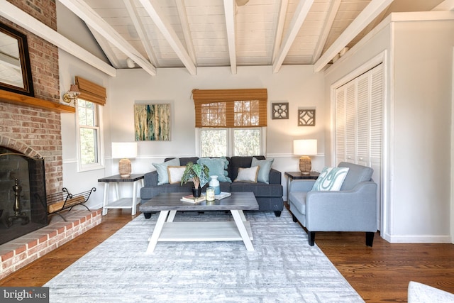 living area featuring wood ceiling, a fireplace, baseboards, and wood finished floors