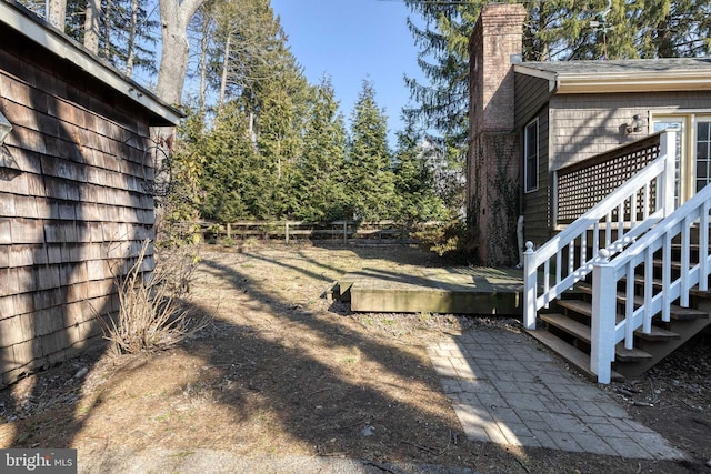 view of yard with a wooden deck and fence