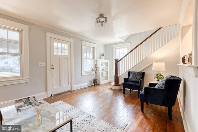 entryway featuring stairs, wood-type flooring, visible vents, and baseboards