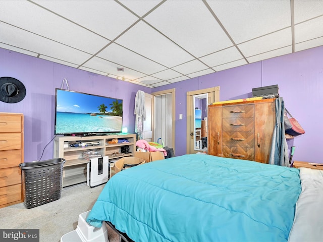 carpeted bedroom with a paneled ceiling