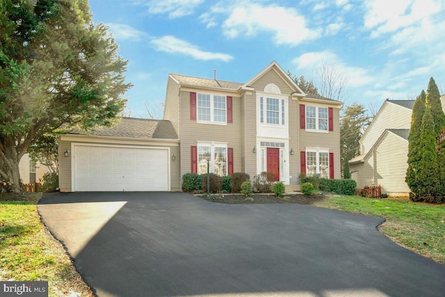 colonial home with a garage and driveway