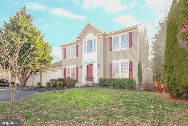 view of front of home featuring a garage, driveway, and a front lawn