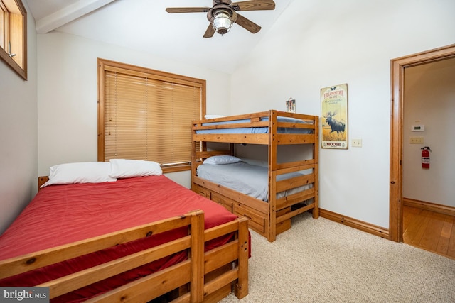 bedroom with a ceiling fan, lofted ceiling, light carpet, and baseboards