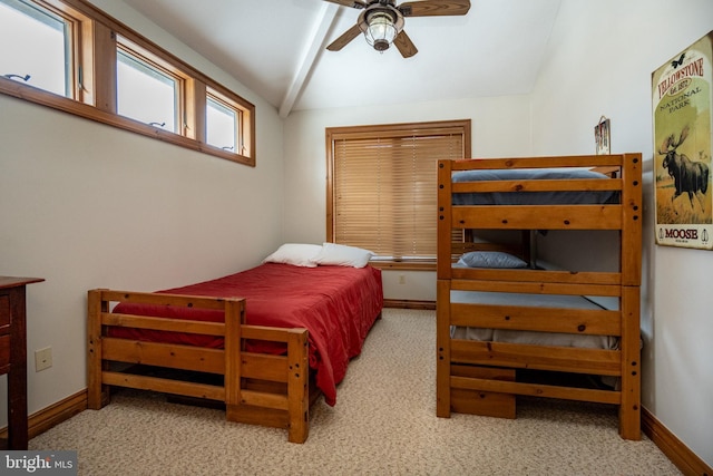 bedroom with lofted ceiling, ceiling fan, baseboards, and light colored carpet