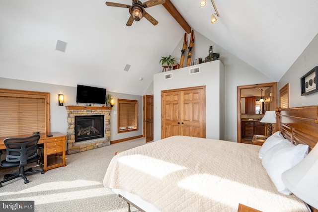 bedroom featuring vaulted ceiling with beams, a fireplace, carpet flooring, and visible vents