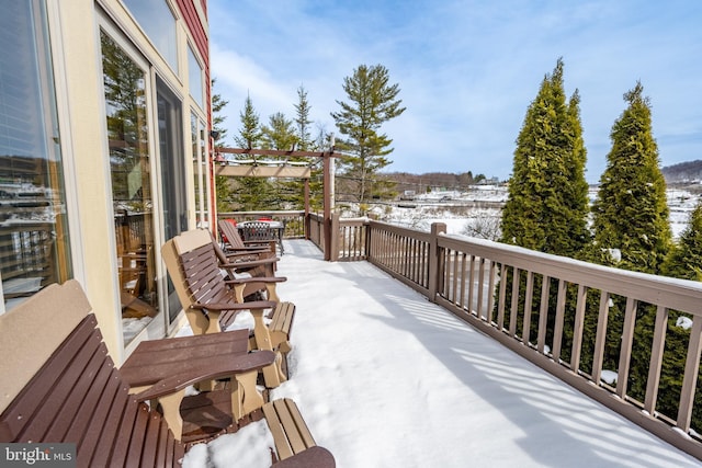 snow covered patio with a pergola