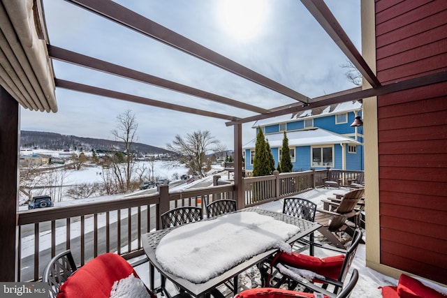 snow covered deck featuring outdoor dining area