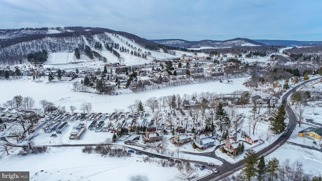 snowy aerial view with a mountain view