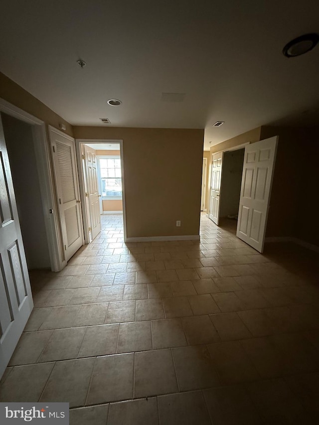 empty room with visible vents and baseboards