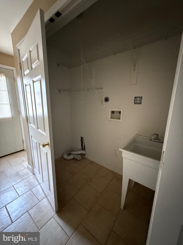 washroom with washer hookup, light tile patterned flooring, and laundry area