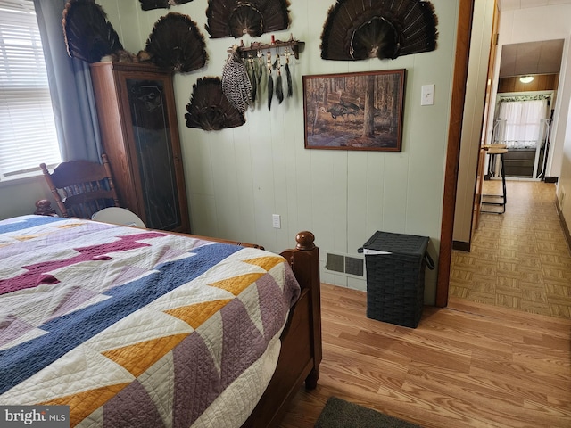 bedroom with parquet flooring and visible vents