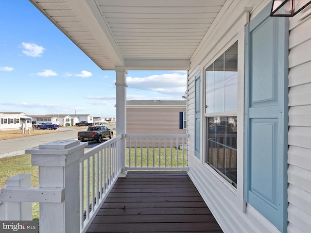 deck featuring a porch and a residential view