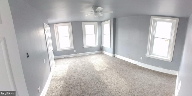 bonus room with ceiling fan and light carpet