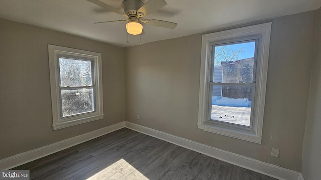 spare room with ceiling fan and dark hardwood / wood-style floors