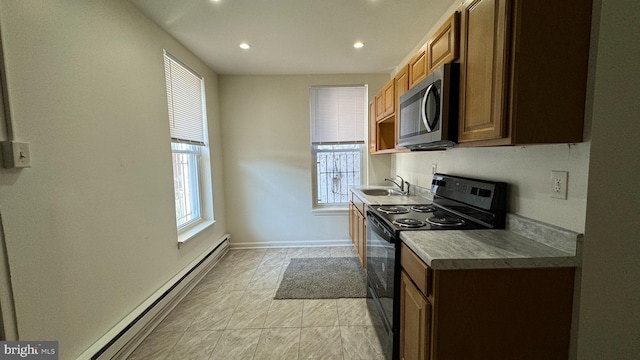 kitchen with black range with electric stovetop, sink, and baseboard heating