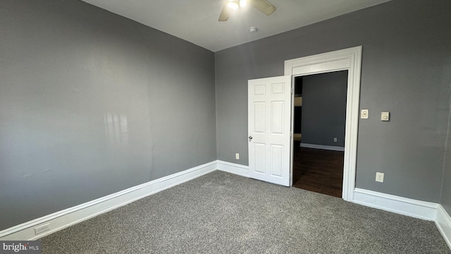 carpeted spare room featuring ceiling fan