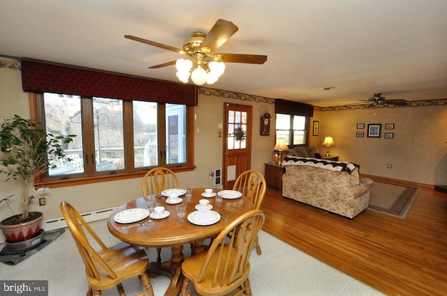 dining room featuring wood finished floors, baseboards, and ceiling fan