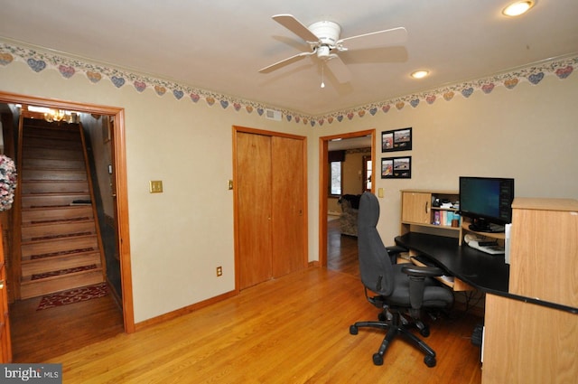 office featuring light wood finished floors, visible vents, baseboards, and a ceiling fan