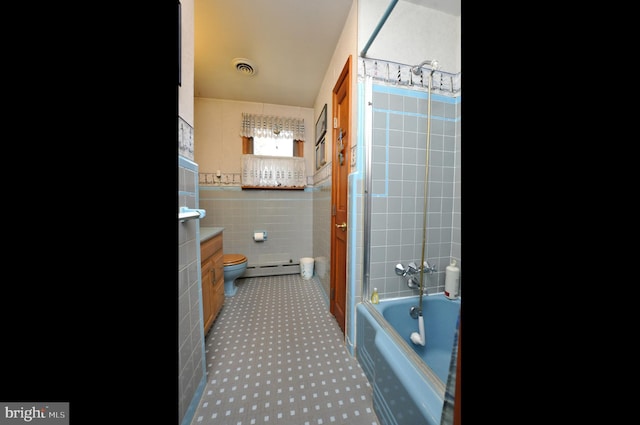 full bathroom with visible vents, toilet, shower / bathing tub combination, tile walls, and a baseboard radiator